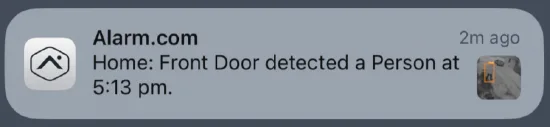 iOS notification from the Alarm.com app reading "Home: Front Door detected a Person at 5:13 pm"