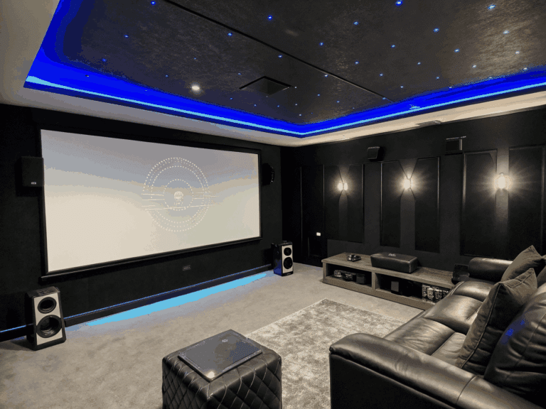 Clean media room installation with flush-mount architectural ceiling speakers and recessed television