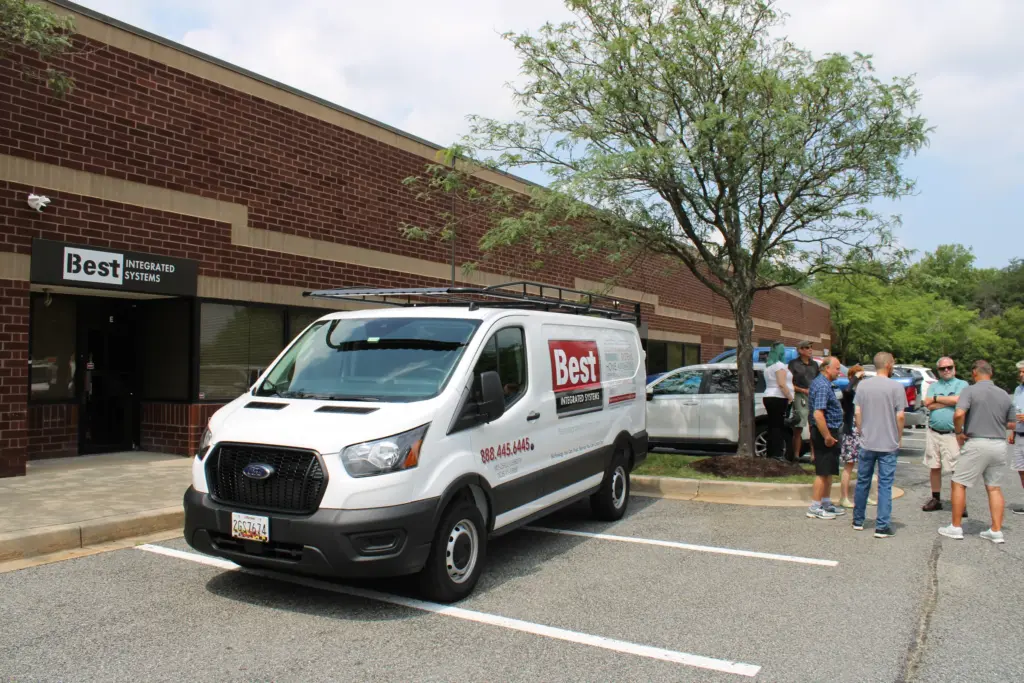 Best Integrated Systems office storefront in Elkridge, MD with a Best Integrated Systems van parked out front during a team event