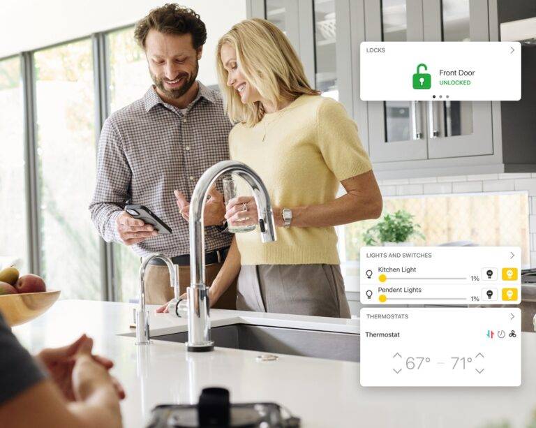 Homeowners using their smart home app in the kitchen, with lock, lighting and thermostat controls